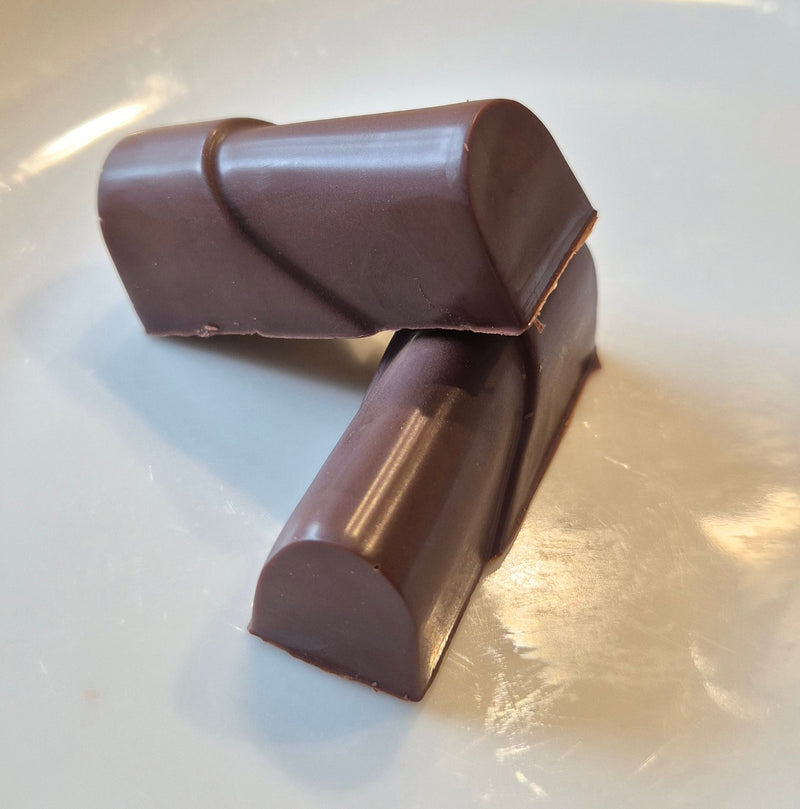Two pieces of chocolate on a white plate