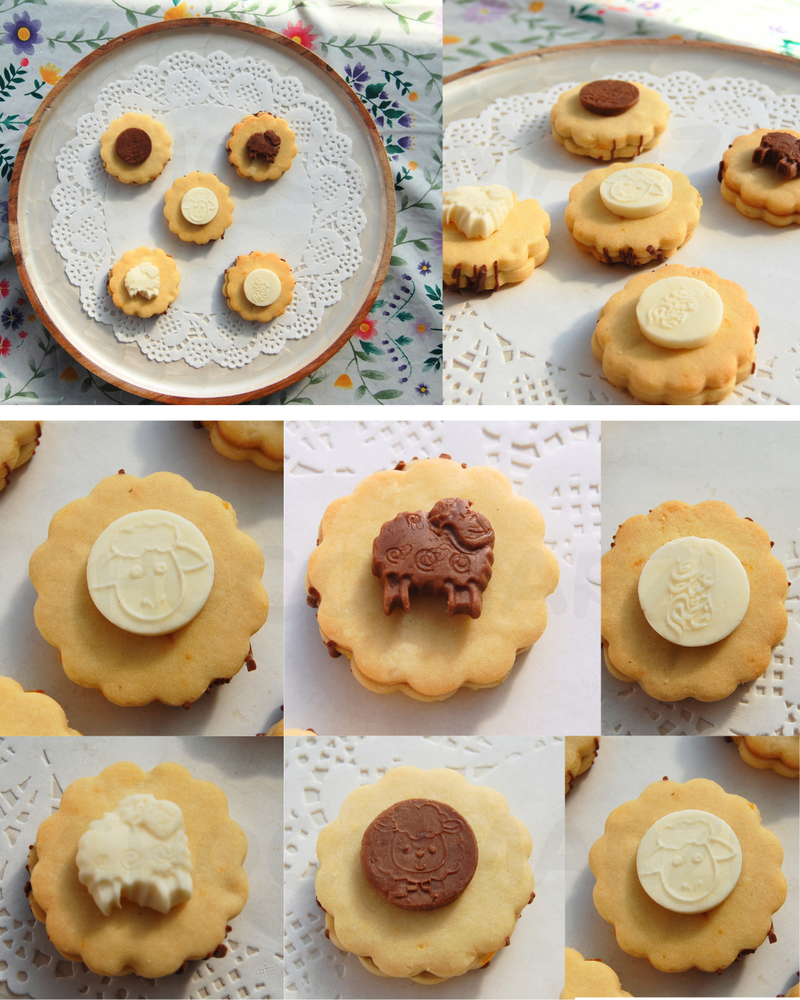 A collage of decorated cookies displayed on white paper doilies and plates. The cookies are golden-brown with various toppings, including white and dark brown molded shapes, shown in multiple close-up and wider views.